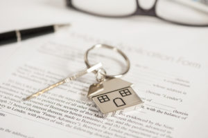 deed papers with keys to house
